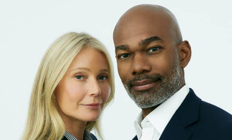 A professional portrait of a white woman and a black man close together, both smiling subtly. The woman has long blonde hair and is wearing a light blazer, while Dr. Julius Few has a closely