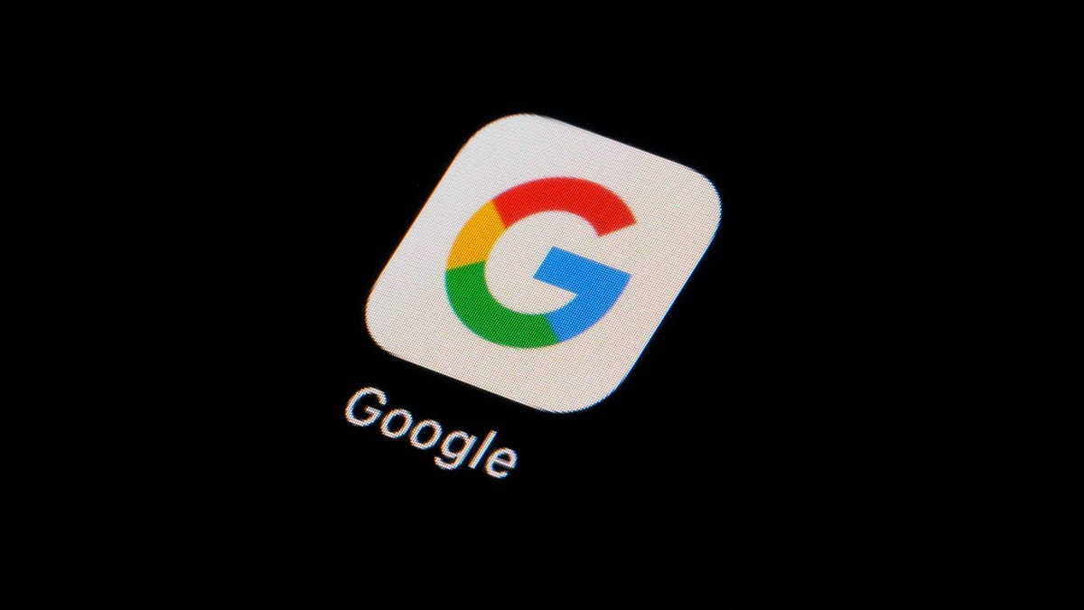 The image shows the Google app icon, featuring a capital letter "g" in colors blue, red, yellow, and green against a white background, displayed on a device screen with a dark, nearly
