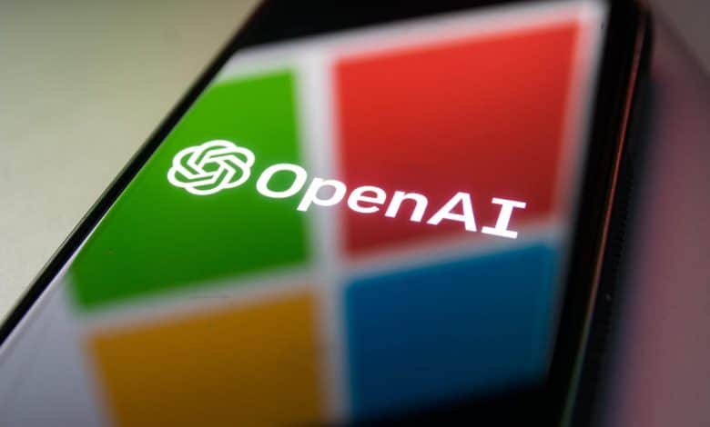 A smartphone screen displaying the OpenAI logo, which features a stylized white 's' in a Microsoft green circular outline, set against a colorful square background split into red, green, blue
