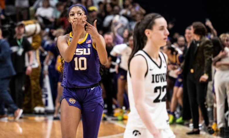 An LSU women's basketball player, number 10, wearing a purple and gold uniform, celebrates on the court with a hand gesture as opponents and spectators surround her in the background during the Elite Eight.
