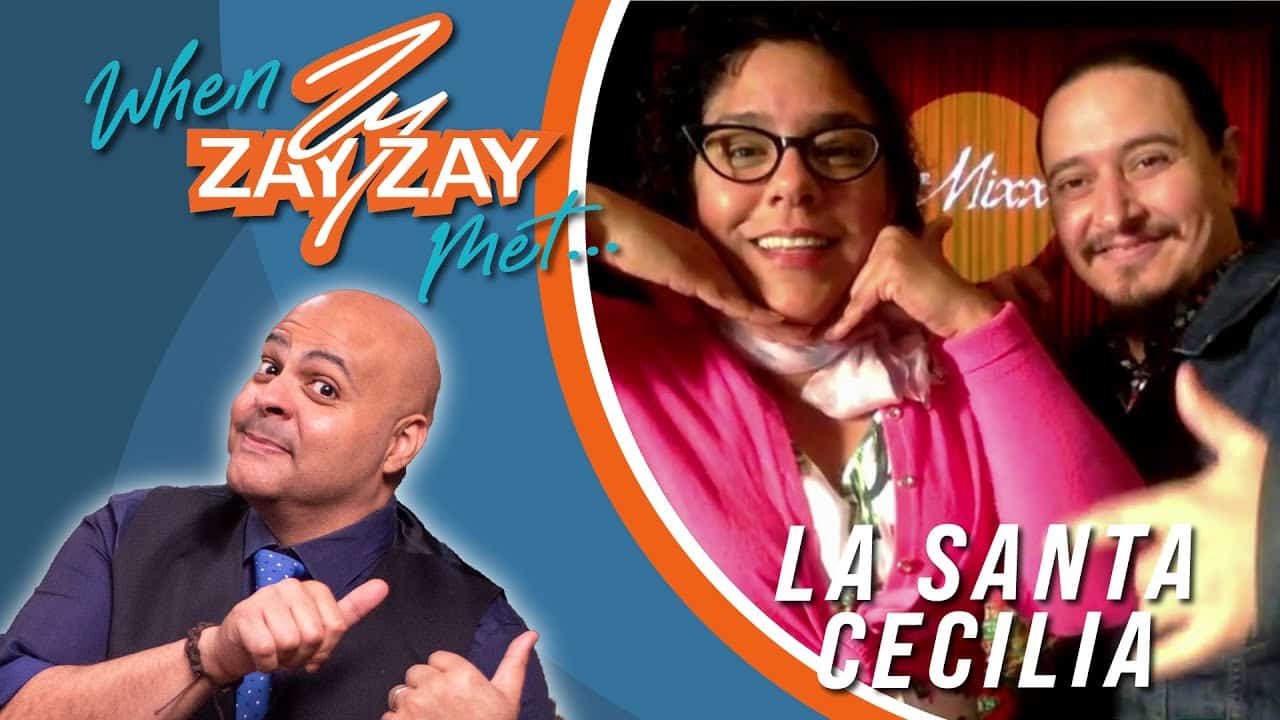 Promotional image featuring a bald man pointing at himself on the left, and a man and a woman smiling on the right, labeled "when zayzay met... La Santa Cecilia." Bright