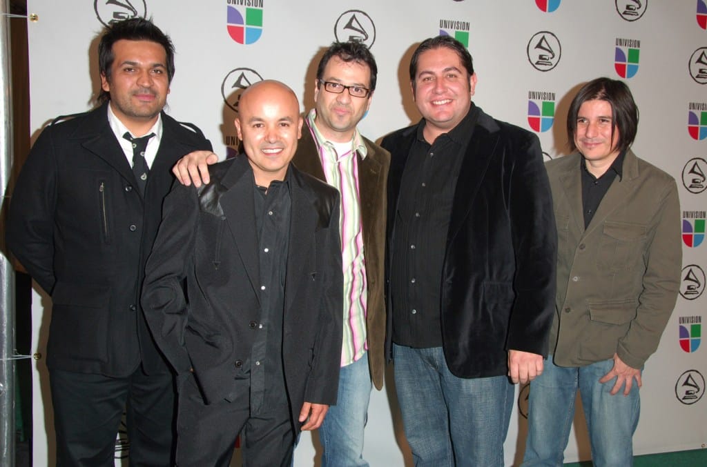 Five men posing together at an event, four dressed in dark jackets and one, ex-Nortec star Jorge 'Clorofila' Verdín, in a pink and white striped shirt. They
