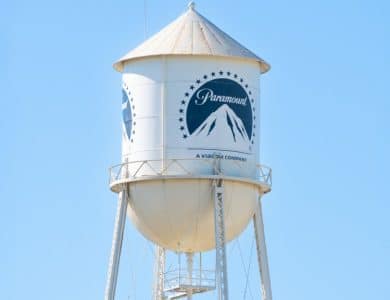 A white water tower with the paramount pictures logo and the words "paramount," "a viacom company" under a clear blue sky during the streaming wars.