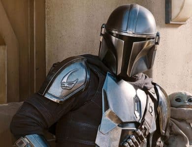 The Mandalorian in full armor stands next to Baby Yoda, who looks up from a pouch. They are surrounded by a desert-like, mechanical backdrop inspired by 'Star Wars' 2026 Disney