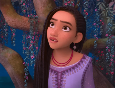 An animated young girl with long, dark hair and large eyes looks anxiously to her right. She stands near a tree adorned with vibrant pink flowers, with a dimly lit blue background suggesting evening or