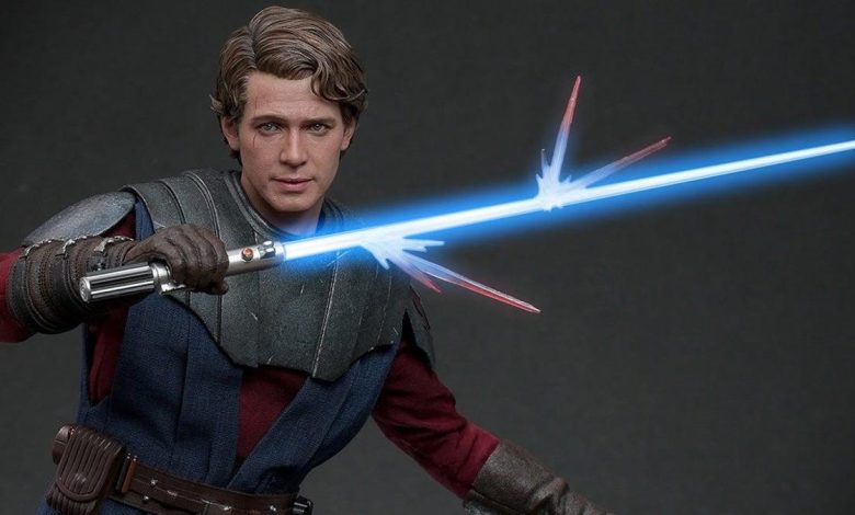 A realistic figurine of a young man with wavy hair, wielding a light saber with blue beams emitting from both ends. He wears a rugged outfit with a grey vest and brown belt, poised for