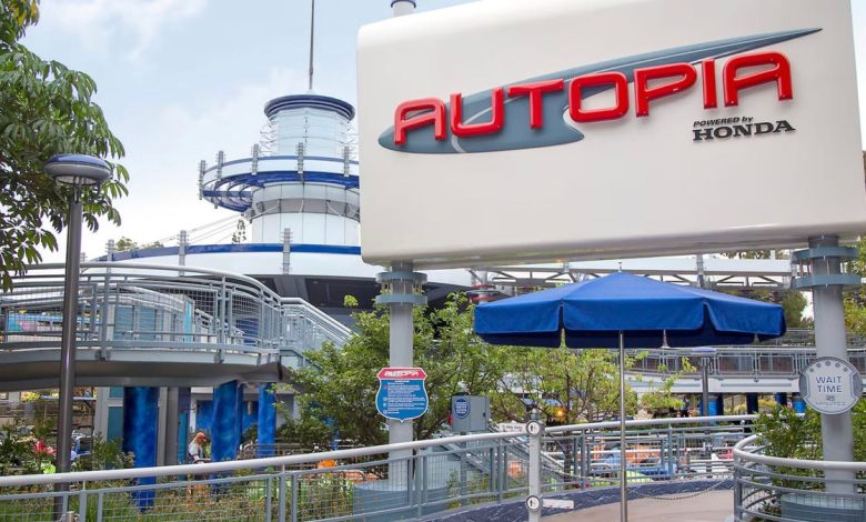 Entrance sign for autopia powered by Honda, featuring a white and red sign against a vivid park scene with lush greenery, snaking pathways, futuristic electric car models, and visitors enjoying the ambiance