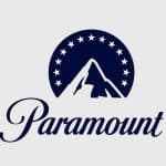 Logo of paramount featuring a stylized mountain peak inside a circle adorned with stars, in dark blue on a light gray background, with the word "paramount" in a curved, elegant script below.