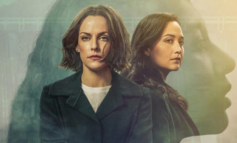 Promotional image for the drama series "Under the Bridge" featuring two women, one with short blonde hair and the other with long brown hair, dressed in dark coats. A shadowy, enigmatic