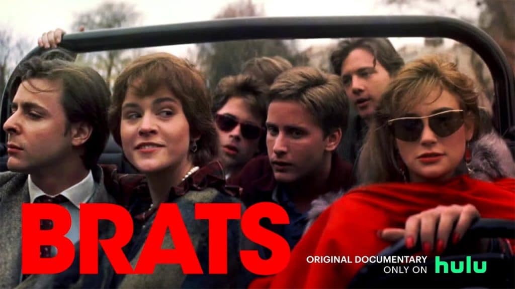 The Brat Pack, A group of young adults is crowded in an open-top car. They appear to be dressed in 1980s fashion. The text "BRATS" in bold, red letters is in the lower left. Below, it reads "ORIGINAL DOCUMENTARY ONLY ON hulu" in smaller white and green text. Trees and buildings are in the background.