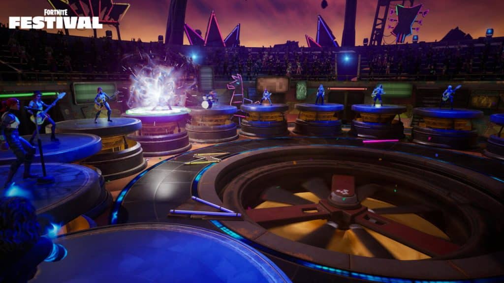 A vibrant scene from Fortnite Festival featuring a circular stage with multiple elevated platforms. Characters are playing musical instruments against a colorful backdrop with lights and decorations. A large fan spins at the base of the stage, with an energy vortex on one platform. Crowd silhouettes in the background.