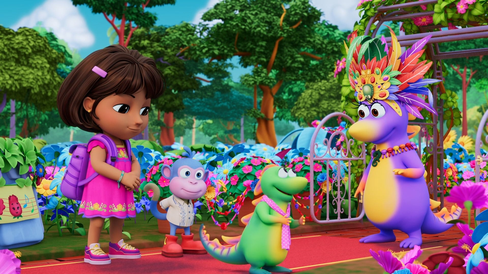 A girl in a pink dress and backpack stands with a blue monkey and a small green dinosaur on a colorful path. They face a purple creature wearing a feathered headdress. The scene is vibrant with lush green trees, bright flowers, and a gate in the background.