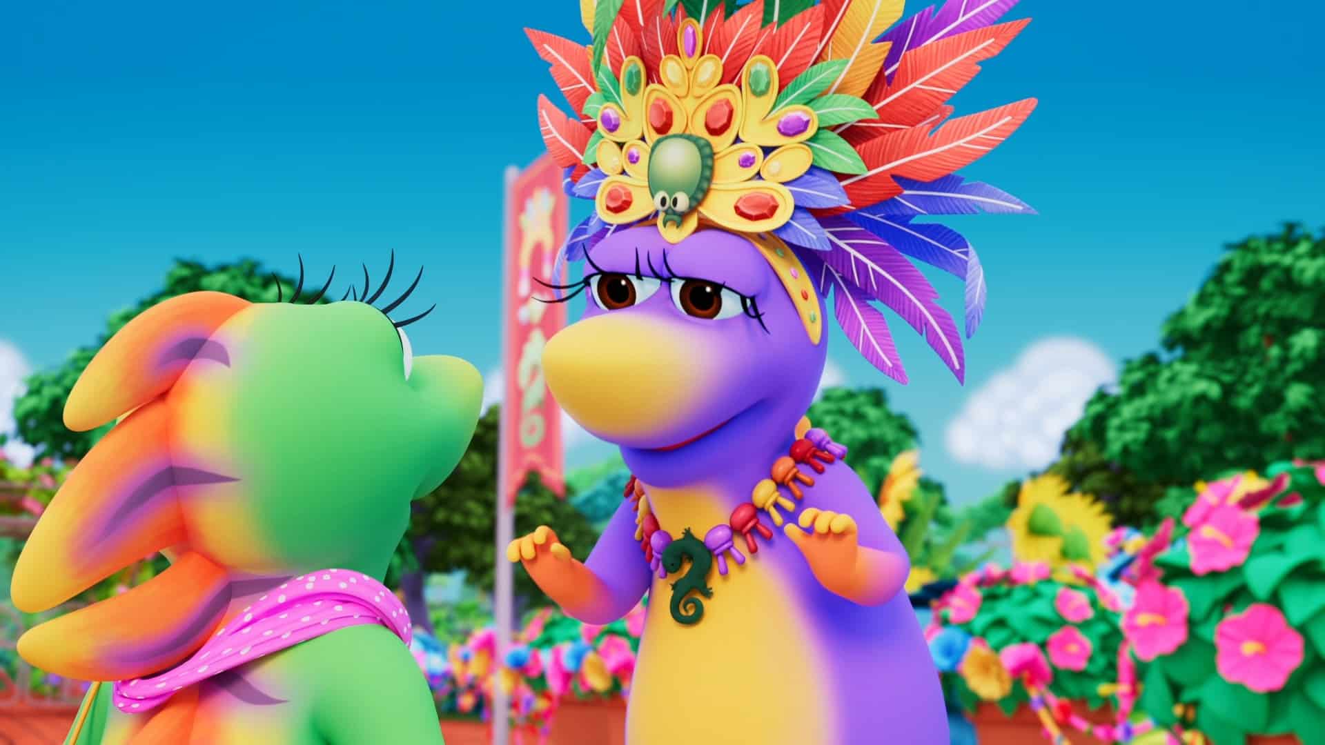 An animated scene with two colorfully dressed dinosaur characters. One purple dinosaur wears a vibrant feathered headdress and multicolored bead necklace, while the green dinosaur, adorned with a pink polka-dot scarf, listens attentively. Lush greenery and colorful flowers are in the background.