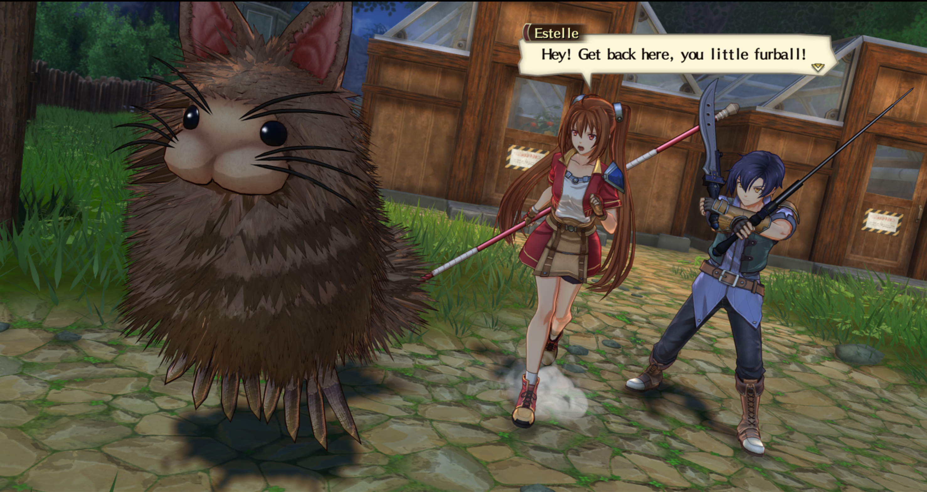 A bushy creature with long whiskers and rabbit-like ears scurries away on a cobblestone path. Two characters chase it, one wielding a staff and the other brandishing a sword. A dialogue box above reads, "Estelle: Hey! Get back here, you little furball!!" A wooden building is visible in the background.