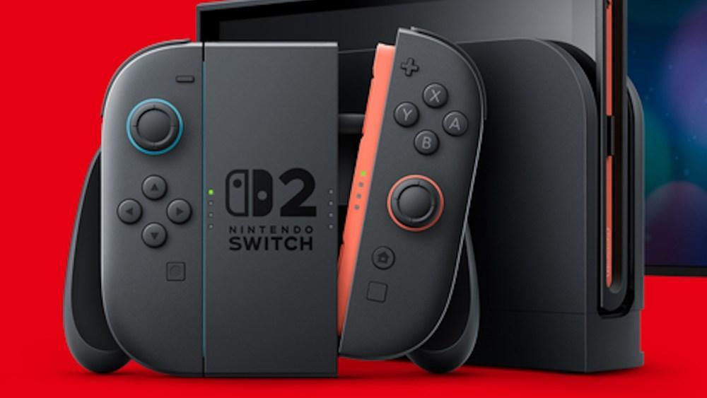 A Nintendo Switch 2 console set against a red background. The console is docked, with Joy-Con controllers attached—one gray and one red. The screen is partially visible in the background, displaying enhanced features. The logo and number "02" are prominently on the front of the dock.