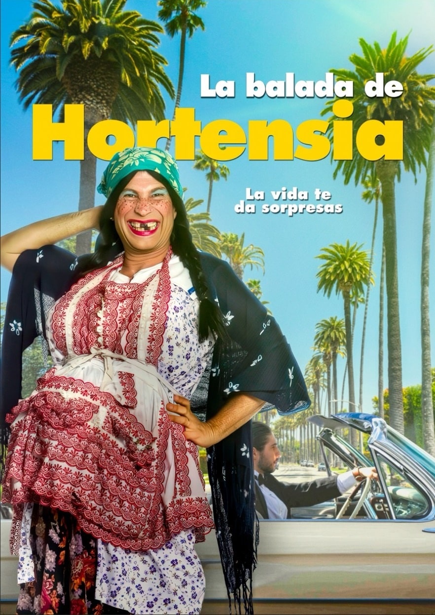 La Tenchis, A smiling woman in traditional, colorful Mexican clothing and headscarf stands beside palm trees and a classic car. Bold white and yellow letters announce “La Balada de Hortensia” and “La vida te da sorpresas.”.
